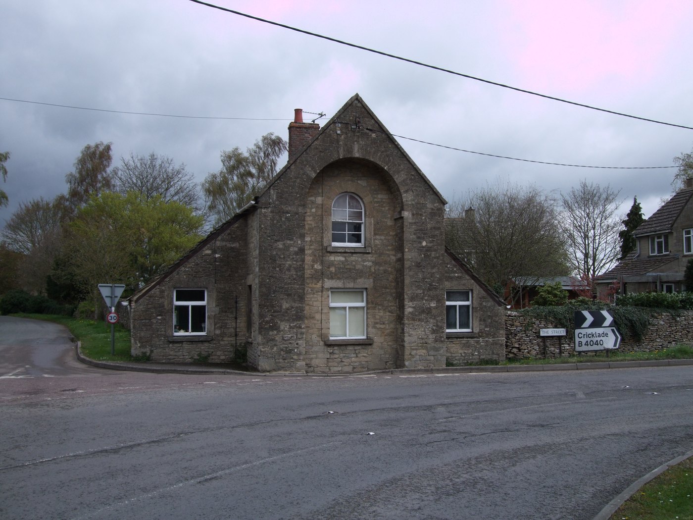 The former toll house on The Street in Charlton, a stone cottage at the roadside